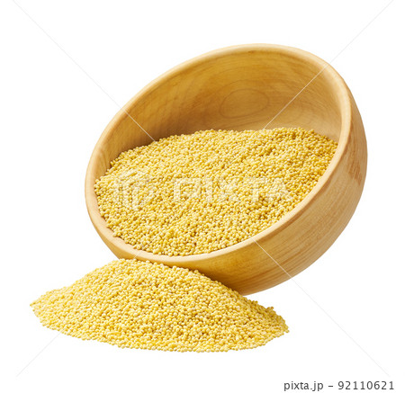 grains of millet are scattered out of the wooden bowl isolated on white background. grains of millet are scattered out of the wooden bowl isolated on white background. 92110621