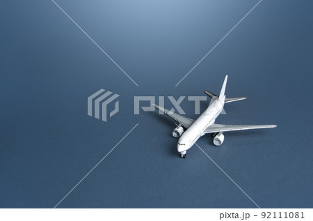 Passenger plane on a blue gray background. Passenger transportation. Business and tourism. Airline operators, air carriers. World communication and commercial flights. Travel. 92111081