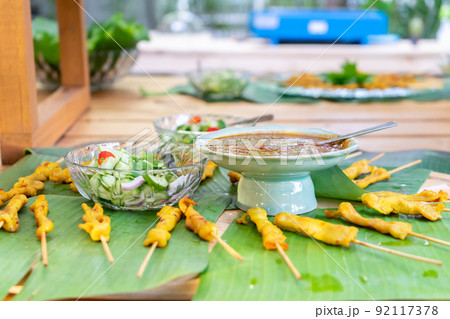 grilled Satay pork, Thailand traditional popular food stick with wood strick, cooked ready to eat with specific sauce beside. 92117378