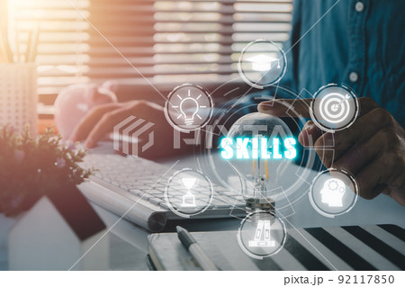 Skill knowledge ability business internet technology concept, Man hand pointing lamp bulb with skills icon on screen display. Skill knowledge ability business internet technology concept, Man hand pointing lamp bulb with skills icon on screen display. 92117850