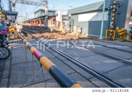 local japanese railroad tracks with home and car parking beside 92118188