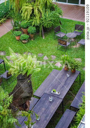 Public garden with wood chair and table on it decorate with little tree around. Public garden with wood chair and table on it decorate with little tree around. 92119109