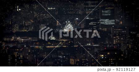 Osaka Castle illuminated at night in panorama / birdeye or top view with cityscape and high building around, Osaka Prefecture, Japan. 92119127