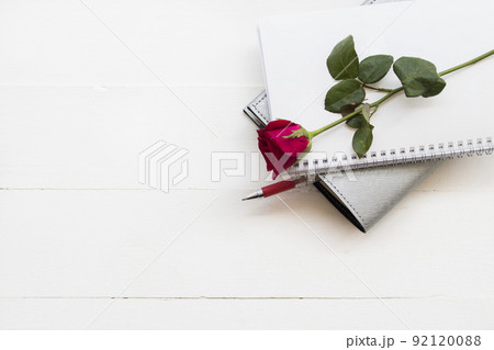 notebook planner for business work with rose flowers arrangement flat lay style 92120088