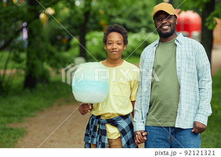 Dad walking with his son in park Dad walking with his son in park 92121321