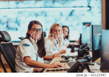 Group of female security operators working in a data system control room Technical Operators Working at workstation with multiple displays, security guards working on multiple monitors in surveillan Group of female security operators working in a data system control room Technical Operators Working at workstation with multiple displays, security guards working on multiple monitors in surveillan 92122967