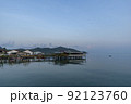 Fisherman's house and seaside house in Sattahip, reflecting with the water surface. Bright sky 92123760