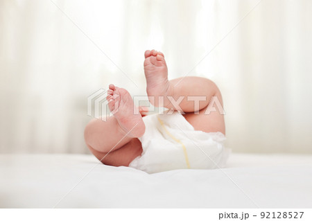 Cute little baby in diaper on bed. Cute little baby in diaper on bed. 92128527