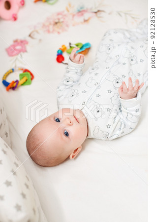 happy newborn baby in crib at home 92128530