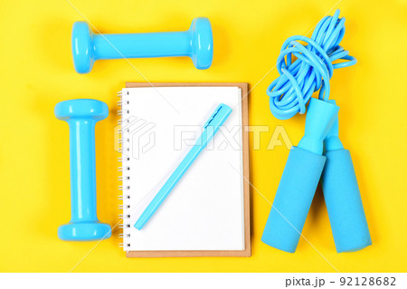 Notepad and fitness tools. Notebook, pen and gym equipment Notepad and fitness tools. Notebook, pen and gym equipment 92128682