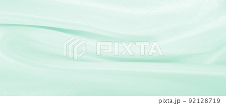 Smooth elegant green silk or satin luxury cloth texture as abstract background. Luxurious background design 92128719