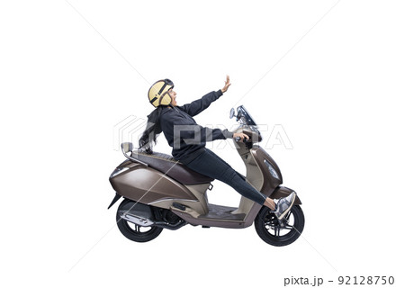 Asian woman with a helmet and jacket sitting on a scooter 92128750