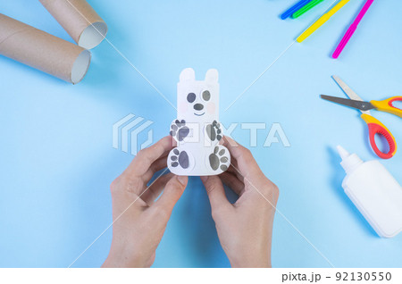 Festive easy DIY craft for children. Roll of toilet paper toy bear on a blue background. Creative decoration eco friendly, reuse, recycling, minimal waste free handmade concept. Festive easy DIY craft for children. Roll of toilet paper toy bear on a blue background. Creative decoration eco friendly, reuse, recycling, minimal waste free handmade concept. 92130550