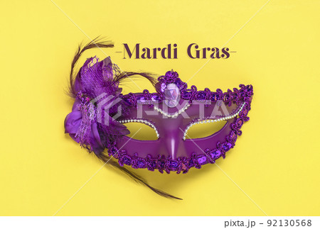 Mardi gras lettering. Congratulation card with violet mask on yellow background Top view 2022 Mardi Gras Parade Schedule Mockup Copy space. Mardi gras lettering. Congratulation card with violet mask on yellow background Top view 2022 Mardi Gras Parade Schedule Mockup Copy space. 92130568