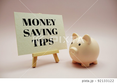 Money Saving Tips text messege and piggy bank on pink background Money Saving Tips text messege and piggy bank on pink background 92133122