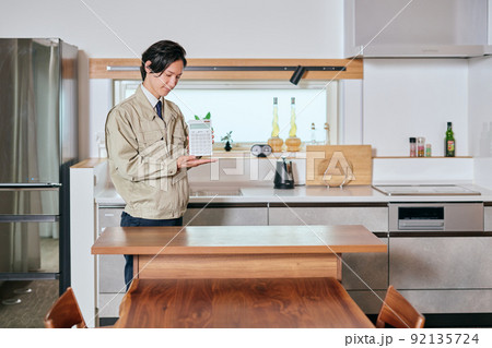 電卓を持つ作業服姿の営業マン 電卓を持つ作業服姿の営業マン 92135724