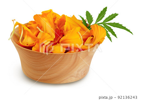 petals of fresh marigold or tagetes erecta flower in wooden bowl isolated on white background with full depth of field. petals of fresh marigold or tagetes erecta flower in wooden bowl isolated on white background with full depth of field. 92136243