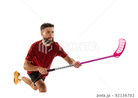 Dynamic portrait of male floorball player with floorball stick in action isolated on white background. Sport, competition and motion, movement, active lifestyle 92136702