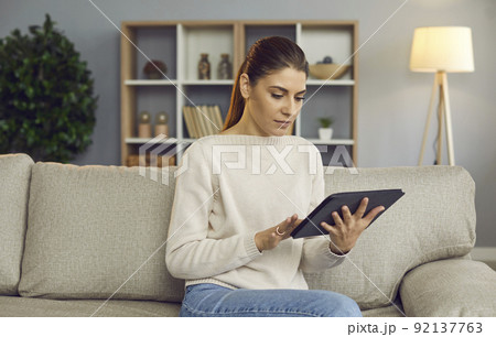 Young woman use modern tablet shopping online 92137763