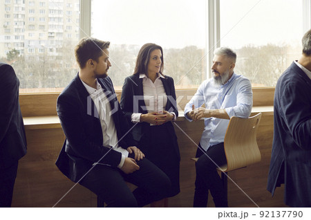 Various colleagues communicate and discuss information after business event or corporate training. Various colleagues communicate and discuss information after business event or corporate training. 92137790