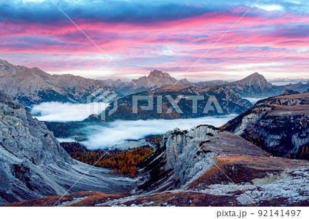 Incredible panoramical view in the foggy morning Dolomites mountains 92141497