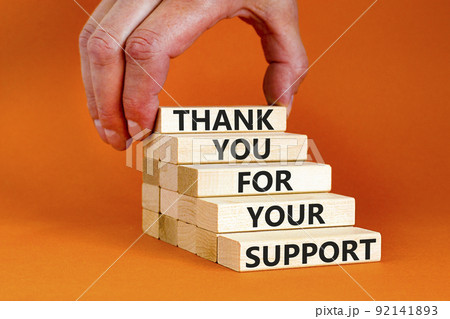 Thank you for support symbol. Concept words Thank you for your support on wooden blocks on a beautiful orange table orange background. Businessman hand. Business and thank you for support concept. 92141893