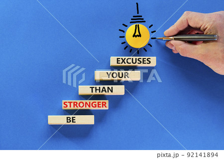 Be stronger symbol. Concept words Be stronger than your excuses on wooden blocks on a beautiful blue table blue background. Businessman hand. Business motivational and be stronger concept. 92141894