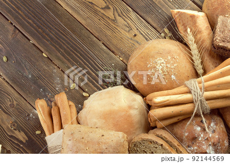 baked bread on wooden table background baked bread on wooden table background 92144569