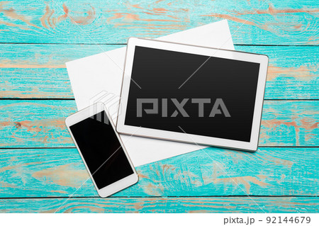White digital tablet on wooden table White digital tablet on wooden table 92144679