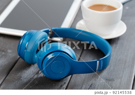 Digital tablet on wooden table in cafe with cup coffee Digital tablet on wooden table in cafe with cup coffee 92145538