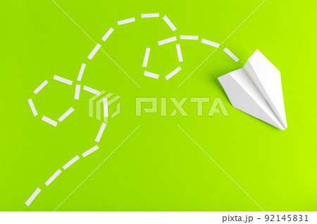 Paper airplanes connected with dotted lines on green background. Business concept Paper airplanes connected with dotted lines on green background. Business concept 92145831