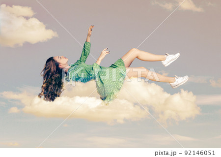 Floating in air. Relaxed girl in vintage ruffle dress levitating keeping eyes closed, sleeping while flying mid-air having comfortable peaceful dream in sky. collage composition on day cloudy blue sky 92146051