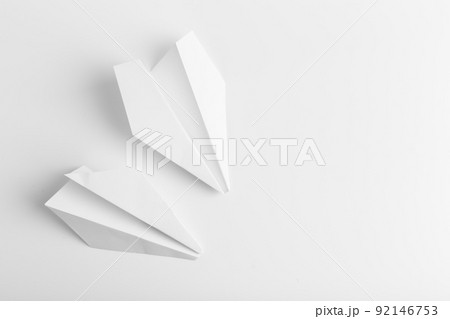 Flat lay of white paper plane on white color background 92146753