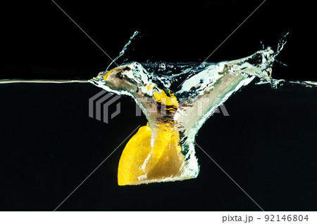 fresh yellow lemon in water splash on black background fresh yellow lemon in water splash on black background 92146804