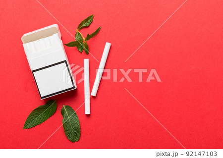 Pack of menthol cigarettes and fresh mint on colored table, Menthol cigarettes top view flat lay Pack of menthol cigarettes and fresh mint on colored table, Menthol cigarettes top view flat lay 92147103