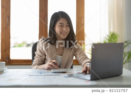 Portrait of attractive asian experienced professional girl agent broker executive assistant calculating income profit at modern loft industrial interior workplace station 92152707