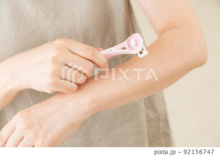 腕の毛を剃るミドル女性 92156747