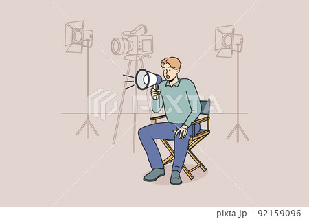 Film producer with loudspeaker at shooting scene 92159096
