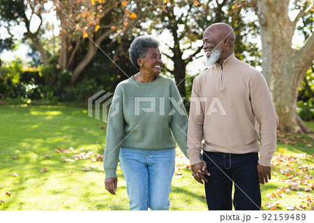 Image of happy african american senior couple in garden Image of happy african american senior couple in garden 92159489
