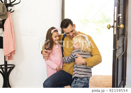 Image of caucasian father returning home from work and welcoming with children Image of caucasian father returning home from work and welcoming with children 92159554