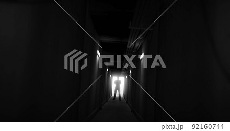 Image of man silhouette standing in dark corridor 92160744