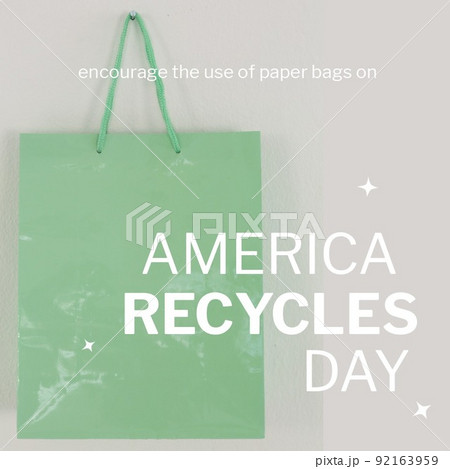 Square image of america recycles day text in white on grey, with green paper shopping bag 92163959