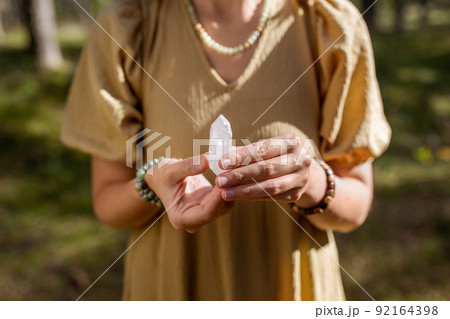 close up of woman holding magical crystal 92164398
