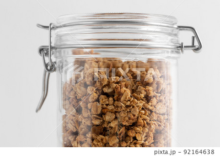 close up of jar with granola or muesli on table close up of jar with granola or muesli on table 92164638