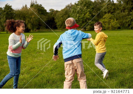 happy children playing and running at park 92164771