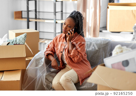 woman calling on phone moving to new home 92165250
