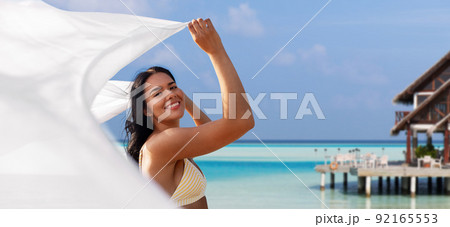 woman in bikini swimsuit with pareo on beach woman in bikini swimsuit with pareo on beach 92165553