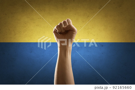 hand making fist pump gesture over flag of ukraine hand making fist pump gesture over flag of ukraine 92165660