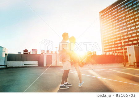 happy young couple on roof top city parking 92165703