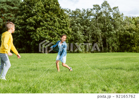 happy children playing and running at park 92165762